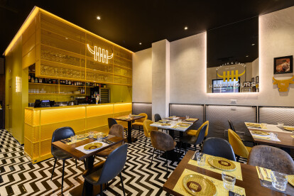 Indoor room with black grid as wall cladding and Italian alternating spike black and white bi-color decorative floor