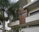 The double height spaces in the interiors are visible in the facade design of the residence.