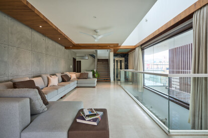 The family room overlooks the double height space into the ground floor, opening up the room visually.