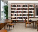 The office library space, where hushed whispers meet the rustle of turning pages, creating an atmosphere of focused serenity amidst the daily hustle.