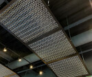 The Banker Wire Dune 4050 flexible wire mesh pattern in stainless steel installed to look like a fishing nets featured in the Hook + Line restaurant.