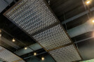 The Banker Wire Dune 4050 flexible wire mesh pattern in stainless steel installed to look like a fishing nets featured in the Hook + Line restaurant.