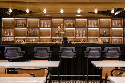 Brass M22-28 woven wire mesh used for cabinetry in the American Express Centurion Lounge in London.
