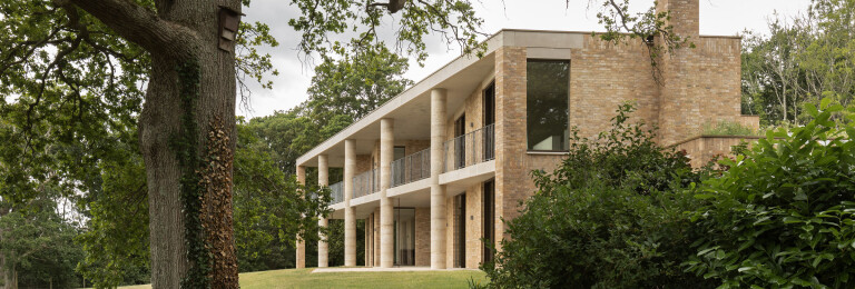 Bespoke replacement luxury dwelling in the South Downs by Sandy Rendel Architects with expansive elevations of frameless glazing.