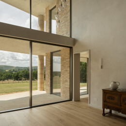 Slim framed sliding glass doors invite far reaching views of the oak woodland.