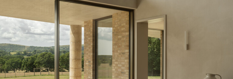 Slim framed sliding glass doors invite far reaching views of the oak woodland.