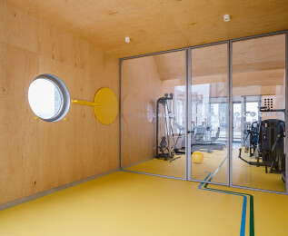 ctivation space and partition to exercise space. Circular window on east façade with revolving shutter.