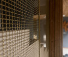 S-40 Woven Wire Mesh in Plated Satin Brass for Staircase Space Divider