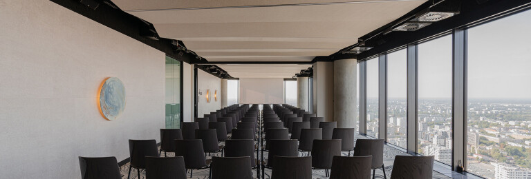 The dynamic pattern of the carpet echoes the burl wood on the walls, the resin bar and the installation under the ceiling of the upper level - all united by the motif of undulating movement.