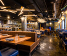 Modern meets comfort in this chic dining space, where warm lighting and sleek geometric lines blend to create an inviting atmosphere perfect for a casual lunch or an elegant dinner affair.