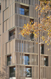 Detail: sliding panels of natural pine protect a residential complex from the Mallorcan sun