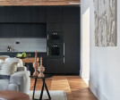 View from the living room towards the custom-made kitchen cabinetry.