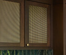 Kitchen remodel installed beautiful new walnut cabinets adorned with Banker Wire’s S-12 woven wire mesh in a plated Antique Brass finish