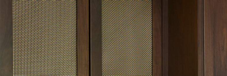 Kitchen remodel installed beautiful new walnut cabinets adorned with Banker Wire’s S-12 woven wire mesh in a plated Antique Brass finish