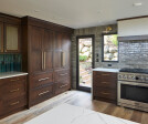 Kitchen remodel installed beautiful new walnut cabinets adorned with Banker Wire’s S-12 woven wire mesh in a plated Antique Brass finish