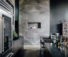The interiors establish a sense of familiarity and rootedness, what the client terms “patina.” Material selections included hot-rolled steel kitchen countertops, concrete floors, smooth trowel stucco and graphite marble.