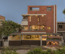 Evening glow on red Agra stone and brick residential facade.